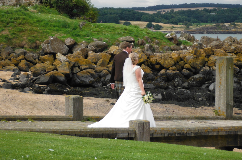  the bride and groom on the wooden jetty