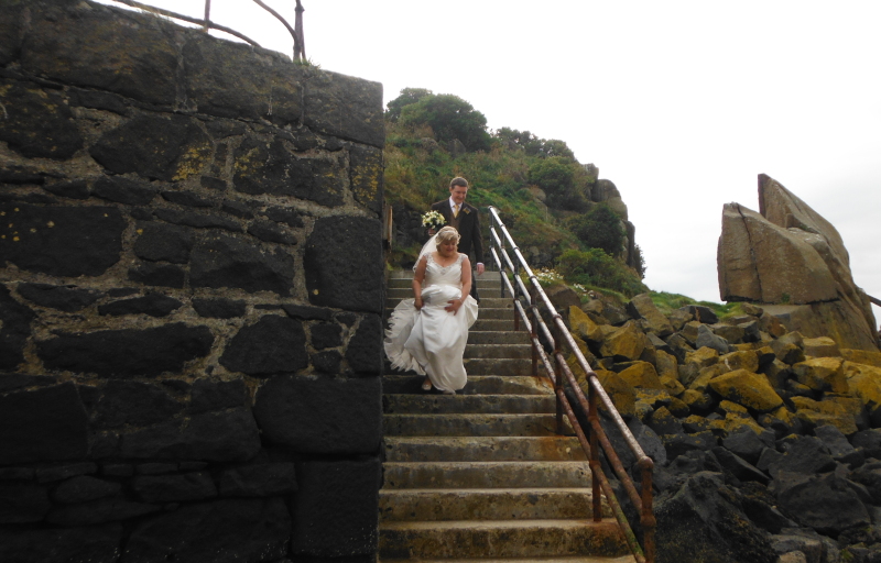  the bride and groom coming down the steps 