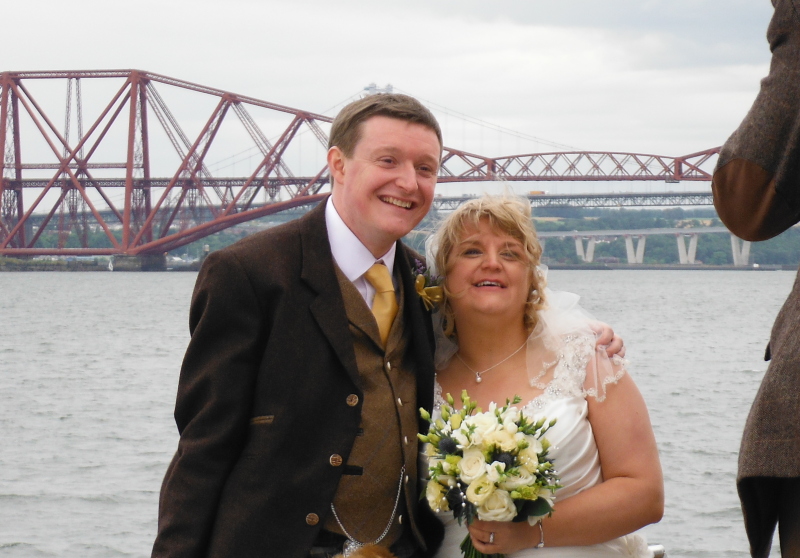  the bride and groom with the railway bridge in the background 