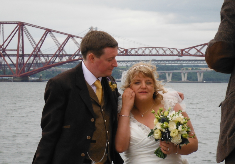  the bride and groom with the railway bridge in the background 