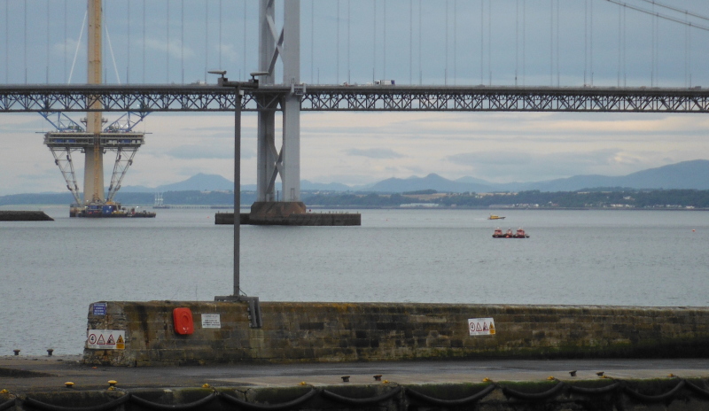  looking out at the mountains visible under the bridge 